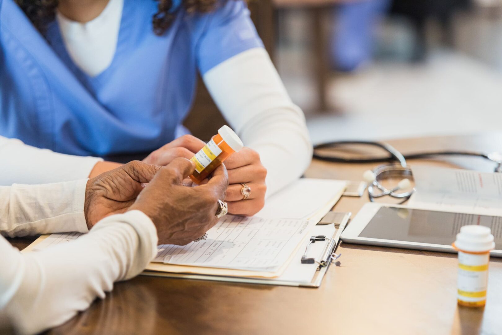 Healthcare professional discussing medication with patient.