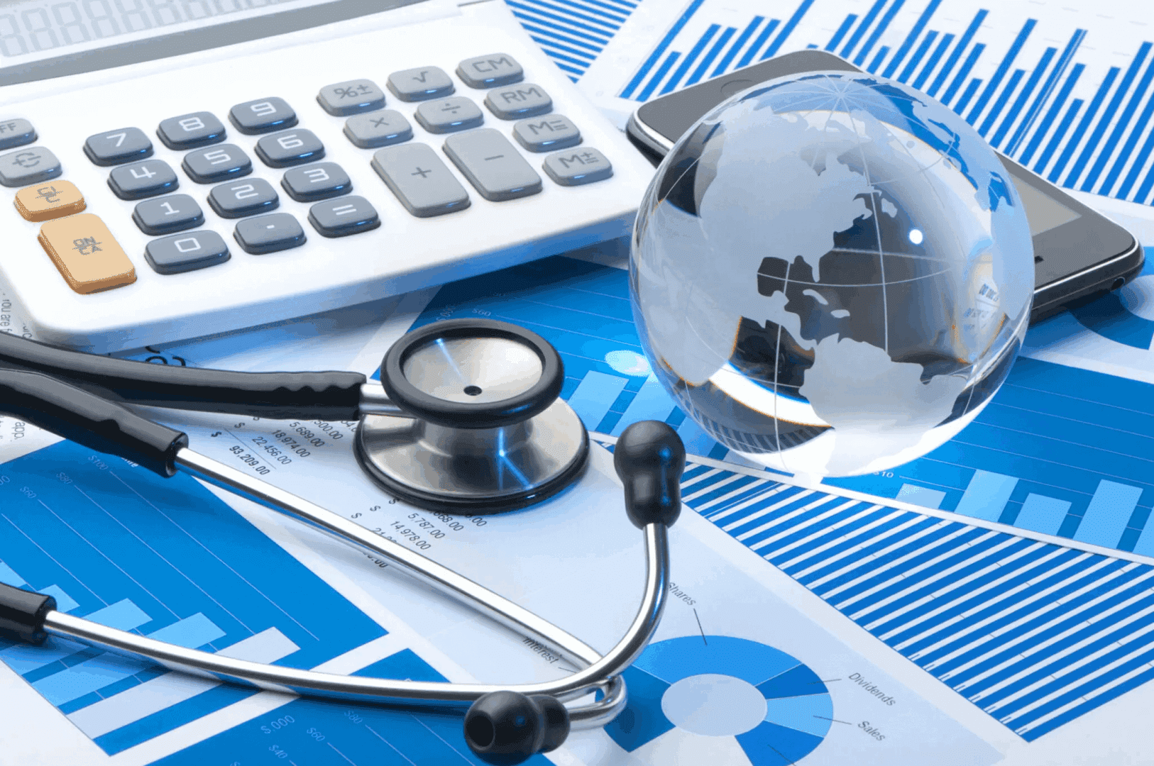Stethoscope and globe on financial charts with calculator nearby.
