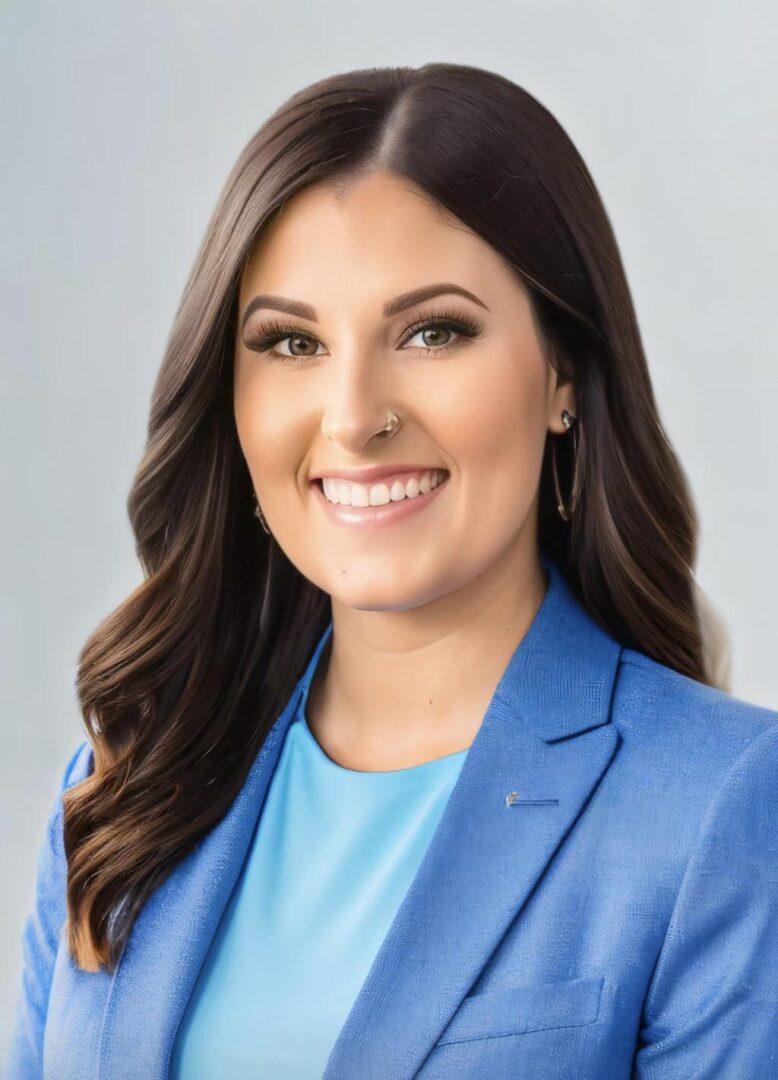 Professional woman in blue blazer smiling confidently.