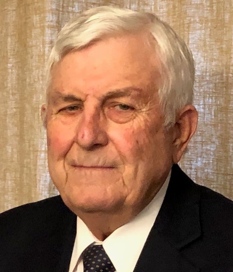 Portrait of an elderly man in formal attire with a neutral expression.